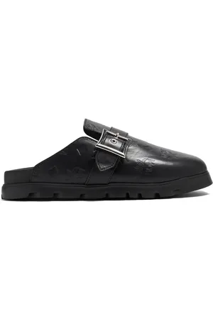 MCM Flache Mules mit Monogramm